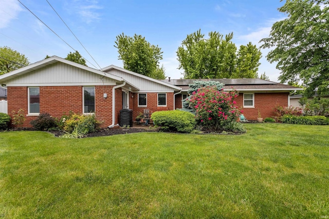 1105 E Southway Blvd, Kokomo, IN 46902 - rear view of property with brick siding, a lawn, and roof mounted solar panels