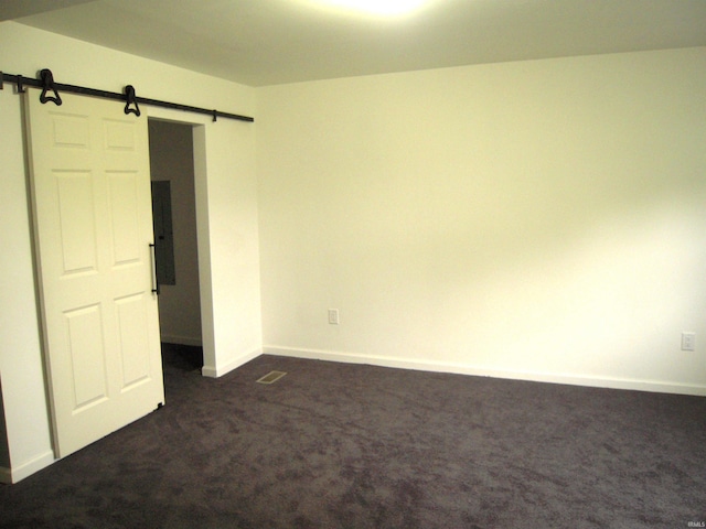 25123 Snyder St, Elkhart, IN 46514 - unfurnished bedroom featuring a barn door, dark carpet, baseboards, and electric panel