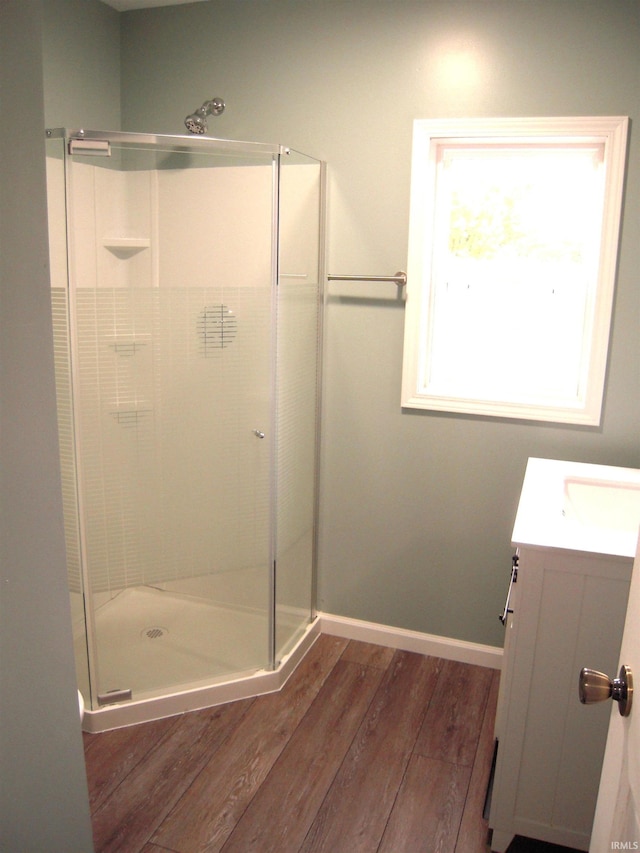 25123 Snyder St, Elkhart, IN 46514 - bathroom with wood finished floors, vanity, a stall shower, and baseboards
