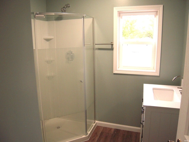 25123 Snyder St, Elkhart, IN 46514 - bathroom with a stall shower, vanity, wood finished floors, and baseboards