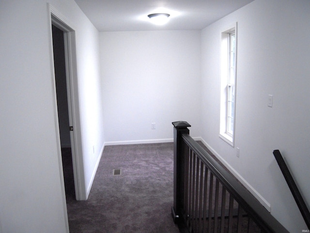 25123 Snyder St, Elkhart, IN 46514 - corridor featuring an upstairs landing, dark colored carpet, and baseboards