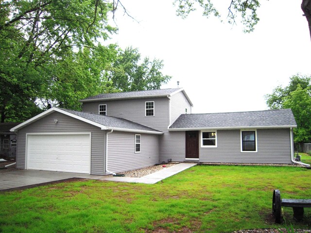 25123 Snyder St, Elkhart, IN 46514 - back of property featuring an attached garage, a lawn, driveway, and roof with shingles