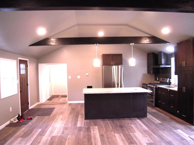 25123 Snyder St, Elkhart, IN 46514 - kitchen with appliances with stainless steel finishes, wall chimney range hood, a sink, lofted ceiling, and a center island