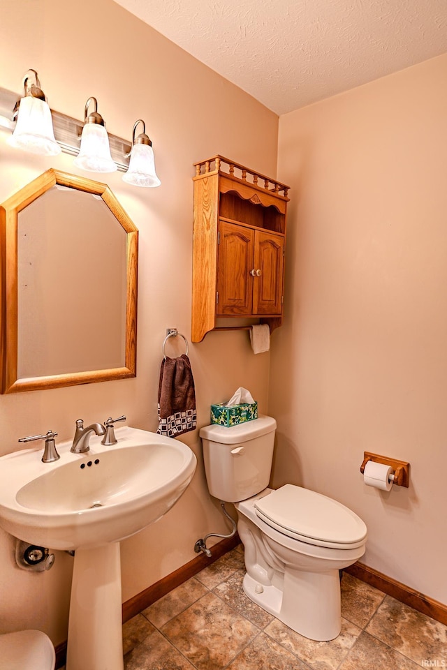 70 Mayflower Ct, Lafayette, IN 47909 - bathroom with toilet, baseboards, a textured ceiling, and a sink