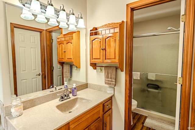70 Mayflower Ct, Lafayette, IN 47909 - full bath featuring a stall shower, vanity, toilet, and wood finished floors