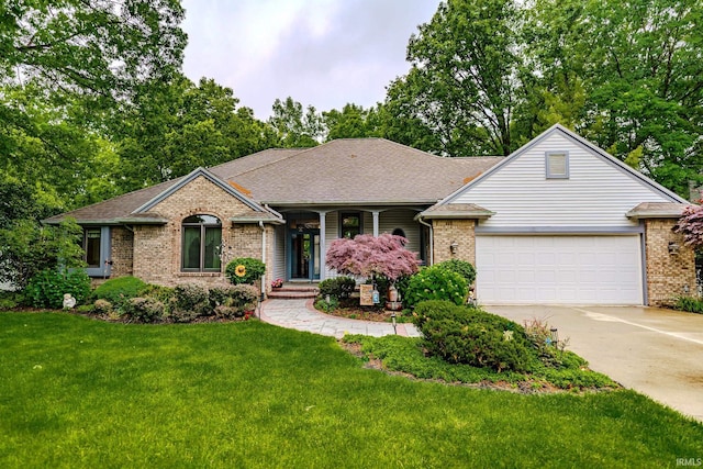 70 Mayflower Ct, Lafayette, IN 47909 - view of front of property featuring brick siding, a garage, driveway, a front lawn, and a shingled roof
