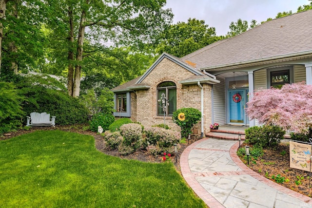 70 Mayflower Ct, Lafayette, IN 47909 - view of front of house featuring brick siding, a front lawn, and roof with shingles