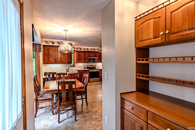 70 Mayflower Ct, Lafayette, IN 47909 - dining area with a chandelier and a textured ceiling