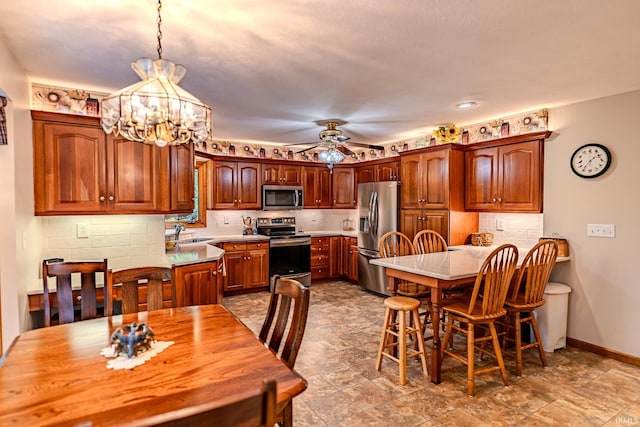 70 Mayflower Ct, Lafayette, IN 47909 - dining space featuring a chandelier, a ceiling fan, and baseboards