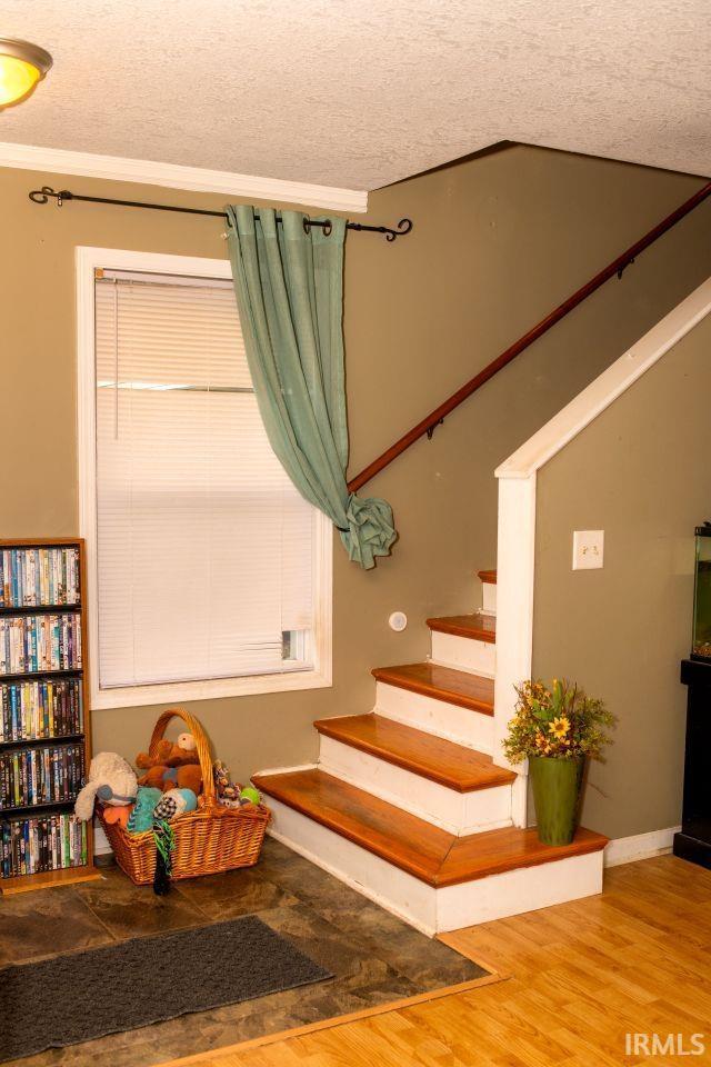 2447 S Meridian St, Marion, IN 46953 - stairs with a textured ceiling and wood finished floors
