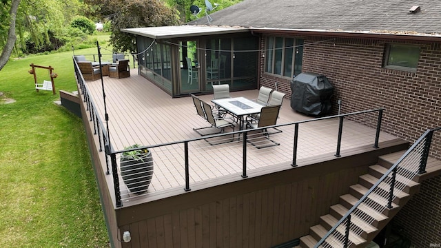 4630 E Armstrong Rd, Leesburg, IN 46538 - wooden deck featuring a sunroom, outdoor dining space, grilling area, stairs, and a lawn