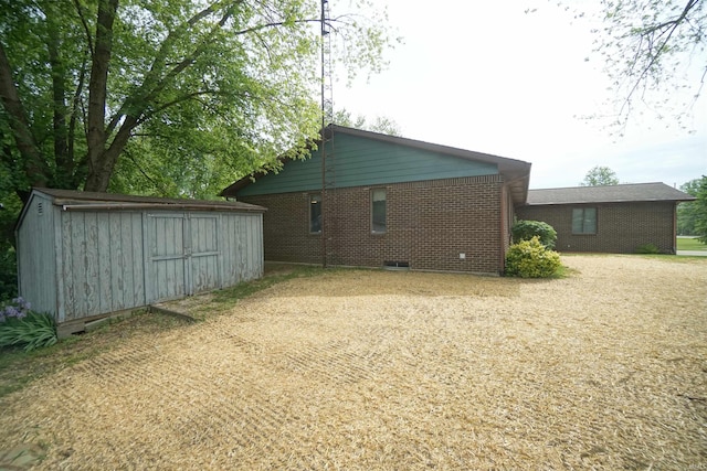 4630 E Armstrong Rd, Leesburg, IN 46538 - view of side of home with brick siding, crawl space, and dirt driveway
