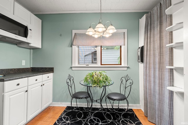726 S Johnson, Bluffton, IN 46714 - kitchen with white microwave, open shelves, a chandelier, and white cabinetry