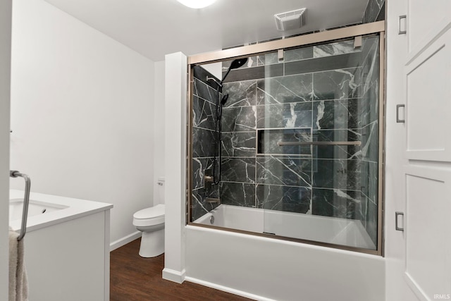 726 S Johnson, Bluffton, IN 46714 - full bathroom with toilet, enclosed tub / shower combo, wood finished floors, vanity, and baseboards
