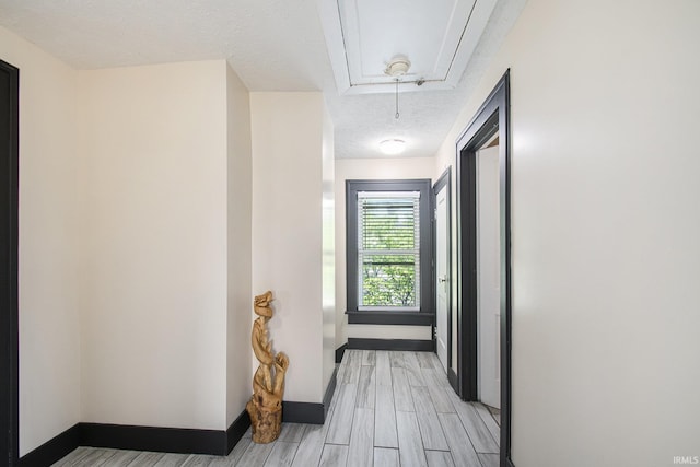 1224 N Main St, Elkhart, IN 46514 - hall featuring attic access, light wood-type flooring, baseboards, and a textured ceiling