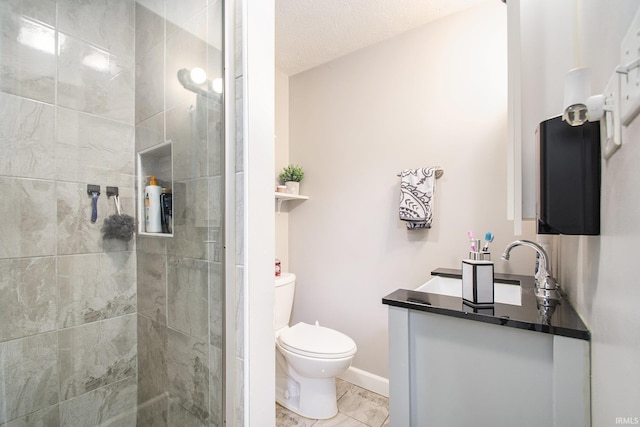1224 N Main St, Elkhart, IN 46514 - bathroom featuring vanity, toilet, a tile shower, tile patterned floors, and a textured ceiling