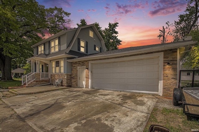 1224 N Main St, Elkhart, IN 46514 - view of front of property with stone siding, concrete driveway, a gambrel roof, a garage, and roof with shingles