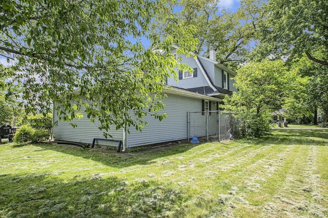 1224 N Main St, Elkhart, IN 46514 - view of home's exterior with a lawn and a chimney