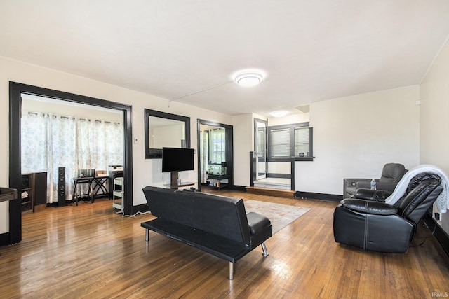 1224 N Main St, Elkhart, IN 46514 - living room with wood finished floors, plenty of natural light, and baseboards