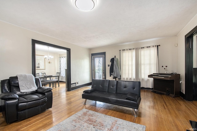 1224 N Main St, Elkhart, IN 46514 - living room featuring wood finished floors and a chandelier