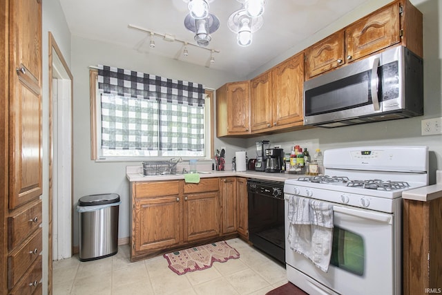 1224 N Main St, Elkhart, IN 46514 - kitchen with stainless steel microwave, white gas range, dishwasher, brown cabinetry, and light countertops