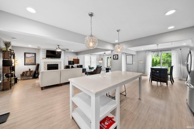 1718 Churchill Dr, South Bend, IN 46617 - kitchen featuring a ceiling fan, light wood-style flooring, recessed lighting, open shelves, and a large fireplace