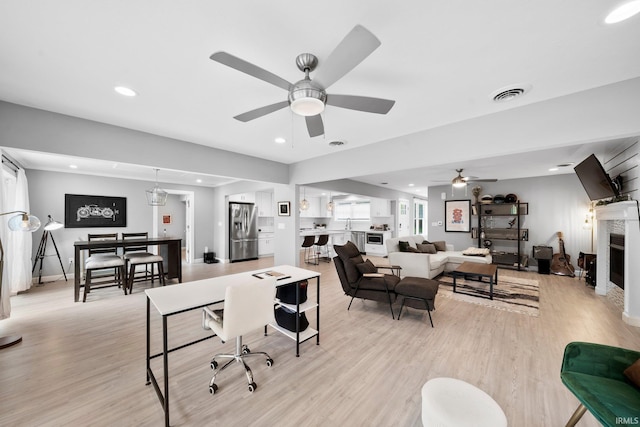 1718 Churchill Dr, South Bend, IN 46617 - living area with ceiling fan, light wood-type flooring, baseboards, a fireplace, and recessed lighting