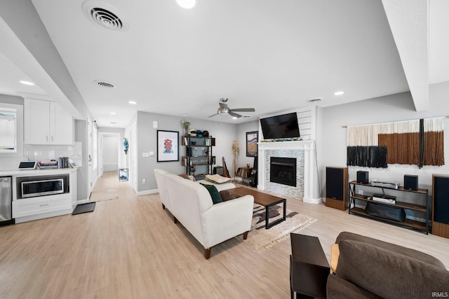 1718 Churchill Dr, South Bend, IN 46617 - living room featuring recessed lighting, baseboards, a ceiling fan, a fireplace, and light wood finished floors