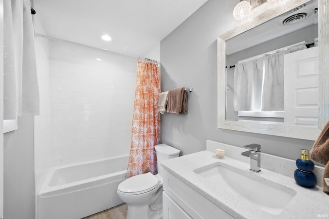 1718 Churchill Dr, South Bend, IN 46617 - full bath with vanity, toilet, shower / tub combo with curtain, wood finished floors, and recessed lighting