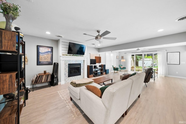 1718 Churchill Dr, South Bend, IN 46617 - living room featuring ceiling fan, light wood finished floors, baseboards, a tile fireplace, and recessed lighting
