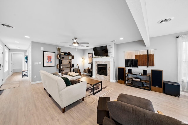 1718 Churchill Dr, South Bend, IN 46617 - living room featuring light wood-type flooring, baseboards, a fireplace, ceiling fan, and recessed lighting