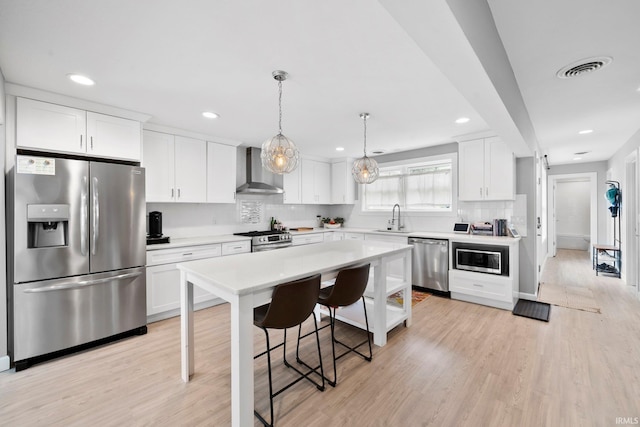 1718 Churchill Dr, South Bend, IN 46617 - kitchen with stainless steel appliances, wall chimney range hood, a sink, tasteful backsplash, and light countertops