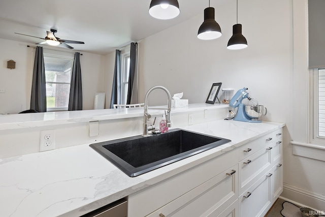 1413 Franklin St, Lafayette, IN 47905 - kitchen with a sink, ceiling fan, pendant lighting, white cabinetry, and light stone countertops