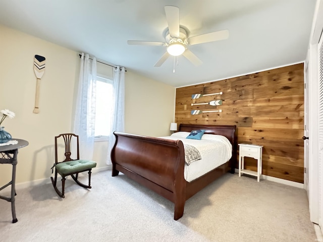 0731 S June Dr, Cromwell, IN 46732 - bedroom with wooden walls, light colored carpet, baseboards, and a ceiling fan