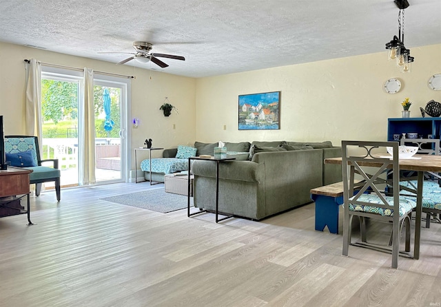 0731 S June Dr, Cromwell, IN 46732 - living area with light wood-style flooring, a textured ceiling, and a ceiling fan