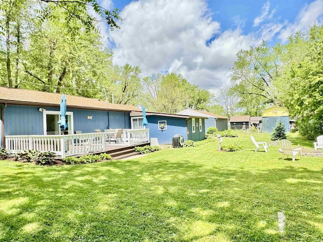 0731 S June Dr, Cromwell, IN 46732 - rear view of house with a deck and a lawn