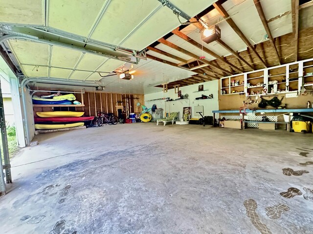 0731 S June Dr, Cromwell, IN 46732 - garage featuring a garage door opener and a workshop area
