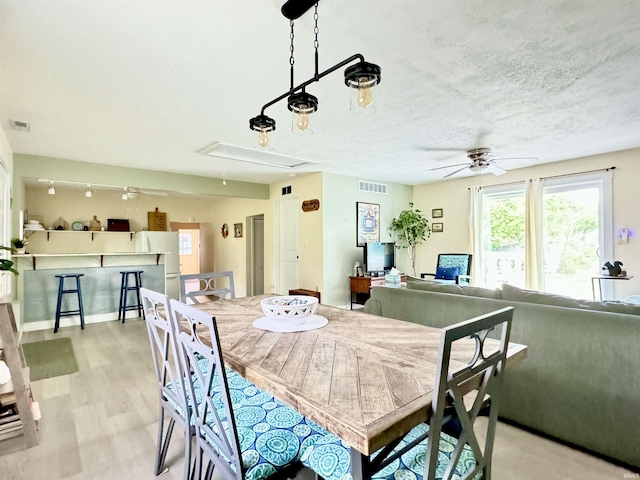 0731 S June Dr, Cromwell, IN 46732 - dining space with attic access, a ceiling fan, and light wood finished floors