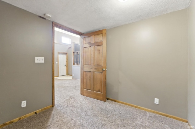 714 Hazel St, Auburn, IN 46706 - unfurnished room featuring carpet floors, a textured ceiling, a smoke detector, and baseboards