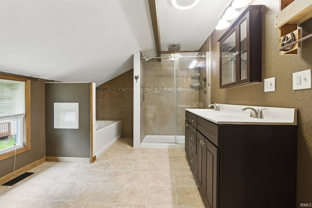 714 Hazel St, Auburn, IN 46706 - bathroom featuring vaulted ceiling, double vanity, tile patterned flooring, a shower stall, and a garden tub
