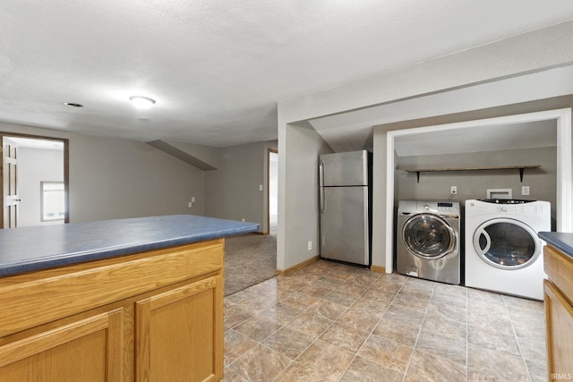 714 Hazel St, Auburn, IN 46706 - kitchen featuring freestanding refrigerator, washer and clothes dryer, dark countertops, and baseboards