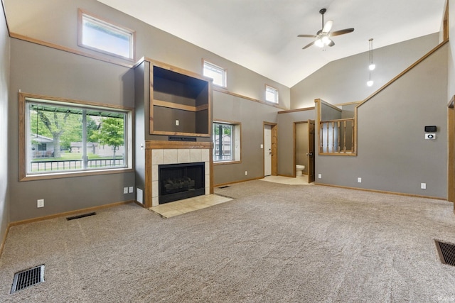 714 Hazel St, Auburn, IN 46706 - unfurnished living room with a ceiling fan, carpet, a tile fireplace, high vaulted ceiling, and baseboards