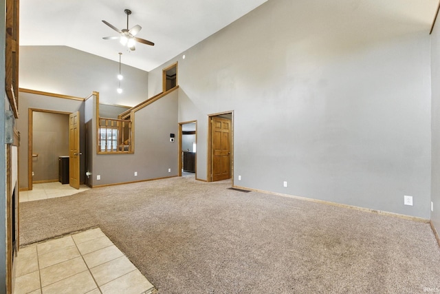 714 Hazel St, Auburn, IN 46706 - unfurnished living room featuring light colored carpet, ceiling fan, high vaulted ceiling, light tile patterned flooring, and baseboards