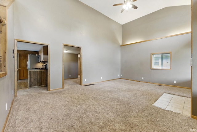 714 Hazel St, Auburn, IN 46706 - empty room with high vaulted ceiling, a ceiling fan, light colored carpet, and baseboards