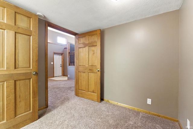 714 Hazel St, Auburn, IN 46706 - spare room with carpet floors, a textured ceiling, a smoke detector, and baseboards