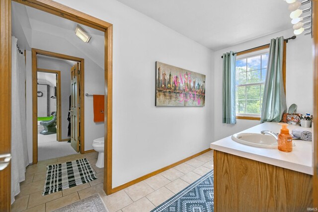 59483 Clover Rd, Mishawaka, IN 46544 - bathroom with toilet, tile patterned floors, double vanity, and vaulted ceiling