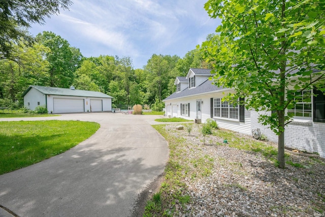 59483 Clover Rd, Mishawaka, IN 46544 - view of front of house featuring a garage, an outdoor structure, a front lawn, and roof with shingles