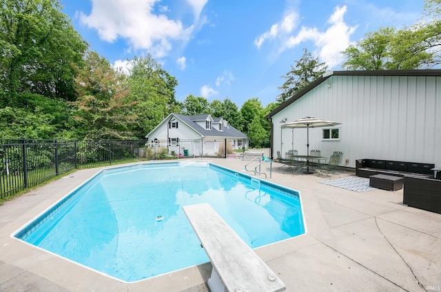 59483 Clover Rd, Mishawaka, IN 46544 - view of swimming pool featuring a patio area, outdoor lounge area, a diving board, and view of wooded area