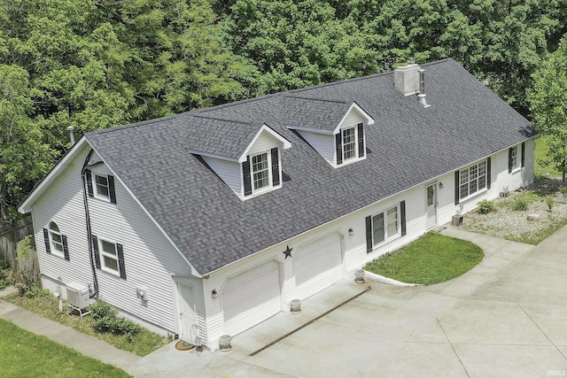 59483 Clover Rd, Mishawaka, IN 46544 - view of front facade with a shingled roof, driveway, a garage, and a chimney