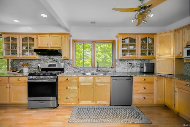 59483 Clover Rd, Mishawaka, IN 46544 - kitchen with dishwashing machine, stainless steel range with gas cooktop, a sink, exhaust hood, and light wood-type flooring